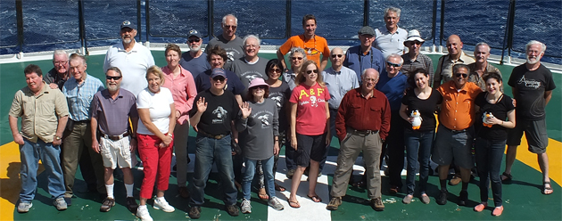 About 30 TCC members joined a cruise from Ushuaia to Cape Verde, centered on a stop at Bouvet Island, but turbulent seas made landing impossible. Though the sea was rocky, these TCC members posed for a group photo — (front row): Mike Bidwell, Don Parrish, Jacquelyn Jerry, Neal Pollock, Laurie Campbell, TCC Treasurer JoAnn Schwartz, Dominique Laurent, Wendy Arbeit, Jagannathan Srinivasaraghavan, Michelle Arbeit; (middle row): Bob Ihsen, Bob Bonifas, Karin Singer, Joao Peixoto, Ed Reynolds, Cathy Parda, Beverly and Harold Griffith, Valentin Sazhin; (back row): Lynn Bishop, Rolf Scheidel, Bob Parda, Phillips Connor, Don Fillman, Dan Walker, Lemut Lent, Harry Mitsidis, Steve Newcomer, Frank Rainer. Those not pictured: William Baekeland, Diana Boyer, Elliot Koch, Carole Ann Peskin, Frank Robinson.