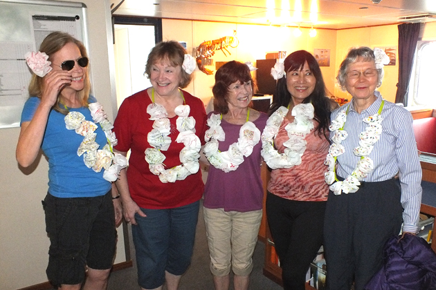 The ships’s bartender promised Pina Coladas one day at sea so the ladies improvised flower leis, using tissues and duct tape. Pictured: JoAnn Schwartz, Diana Boyer, Laurie Campbell, Cathy Parda, Beverly Griffith.