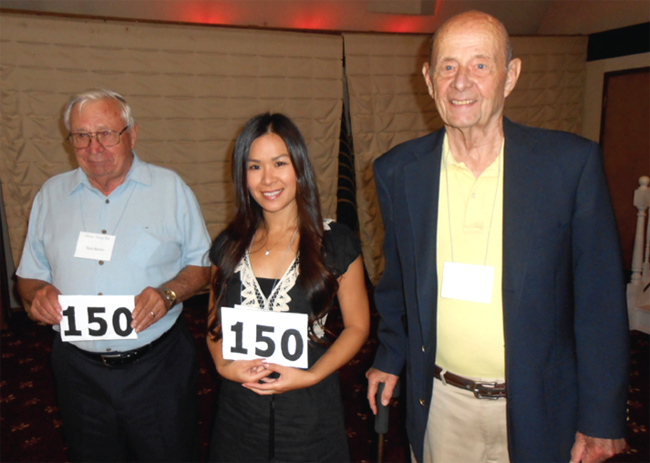 Tim Carlson congratulates Nick Bowles and Lucy Hsu on reaching 150 countries and territories.